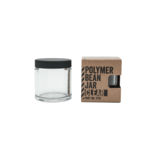 Comandante bønnebeholder i klar med sort låg. Til højre står beholderen i dens emballage med skriften "Polymer Bean Jar Clear"