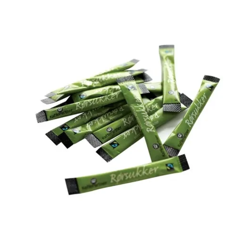 En bunke grønne økologisk rørsukker sticks fra Kaffepartner, spredt ud på en hvid baggrund. Hver stick har Fairtrade-mærket og teksten "Rørsukker" trykt i hvid skrift.