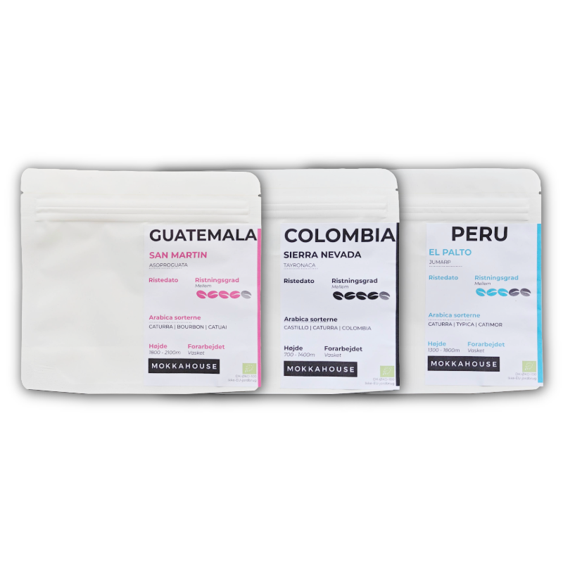 Tre poser økologisk espresso kaffe fra Mokkahouse, med oprindelse fra Guatemala, Colombia og Peru, stående side om side.