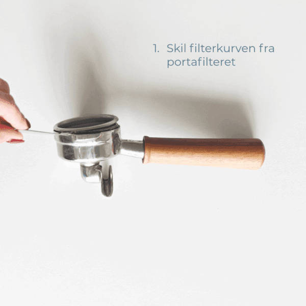 Hånd, der bruger en filterkurv-aftager til at skille filterkurven fra portafilteret.